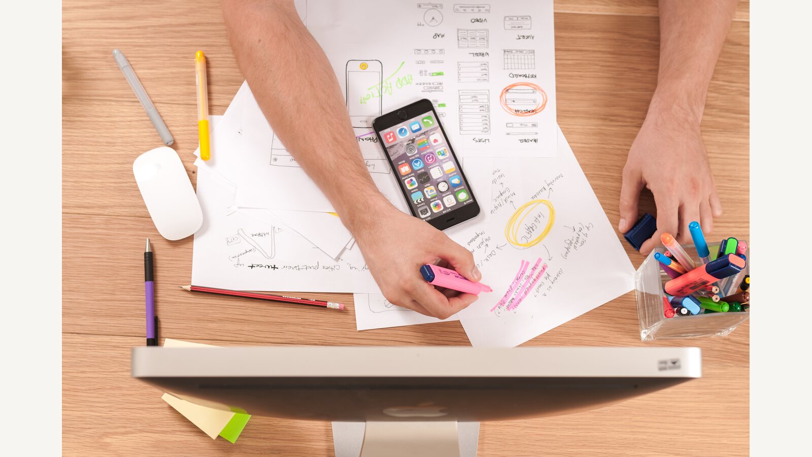 Planning papers and a phone on a work surface