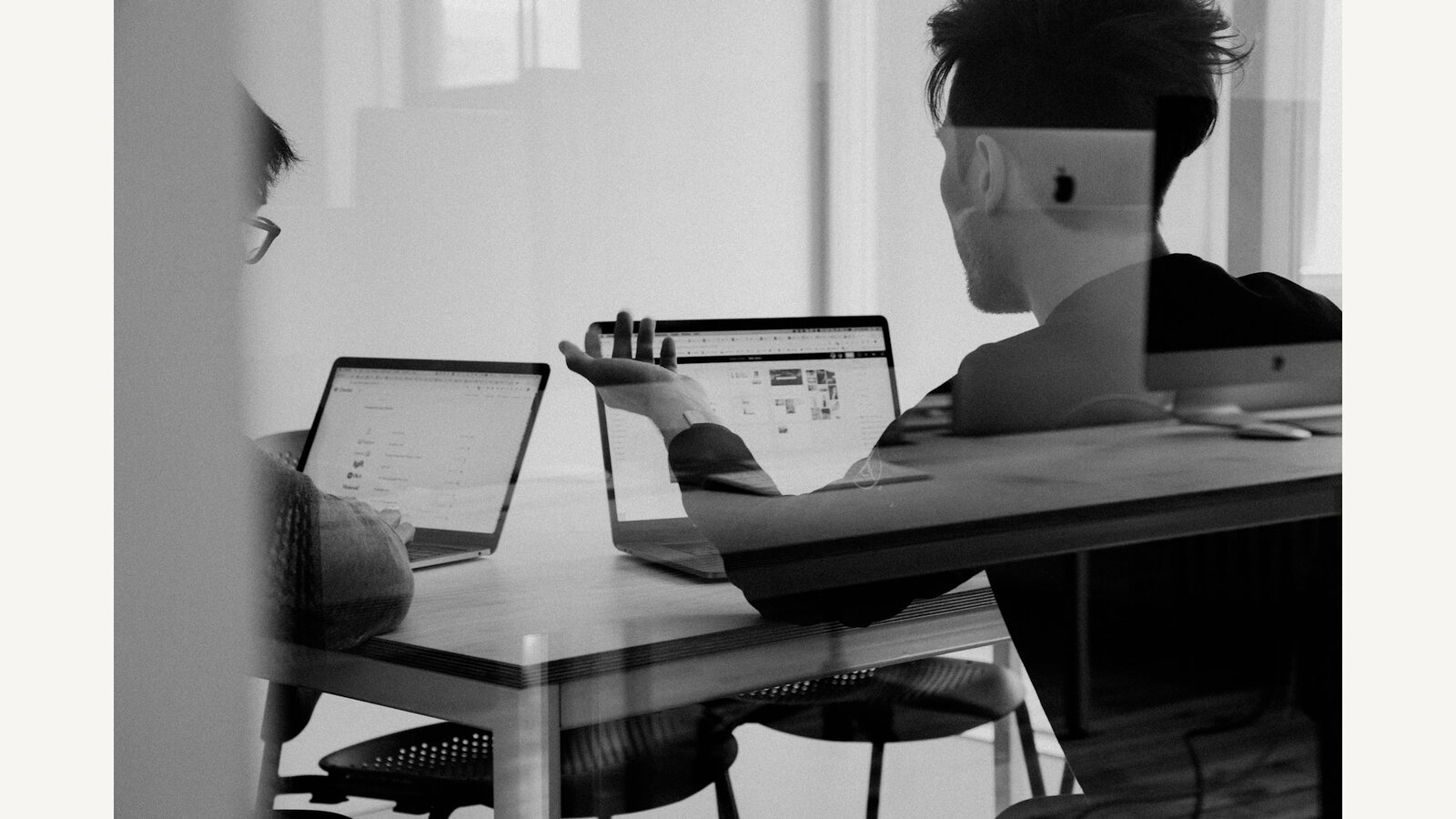 A person working on a laptop in a black-and-white photograph