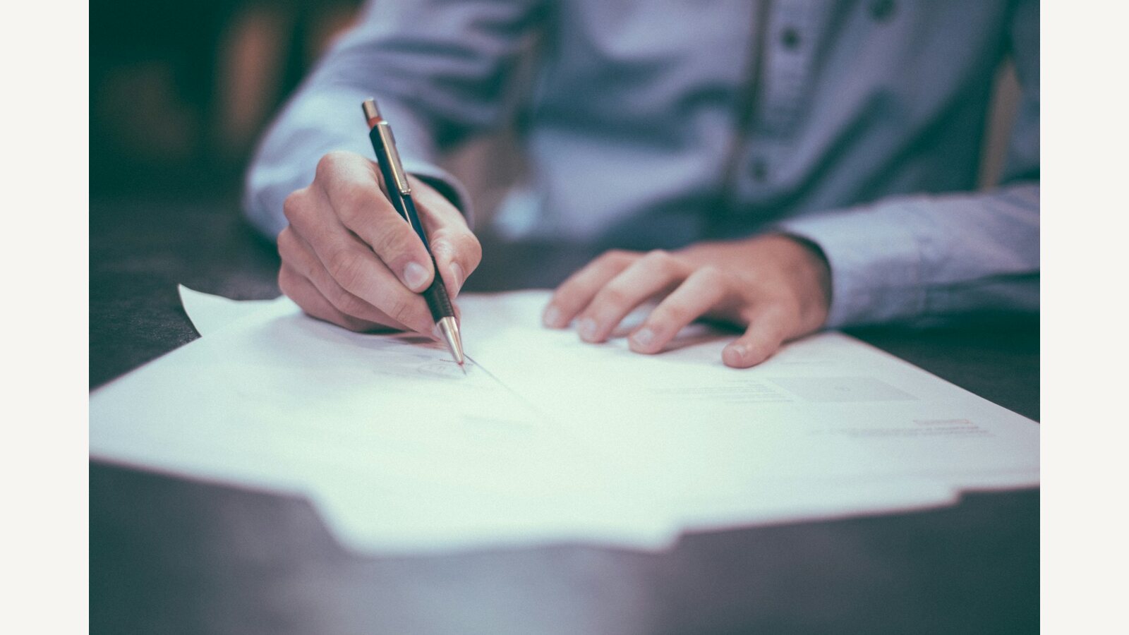 A person writing at a desk